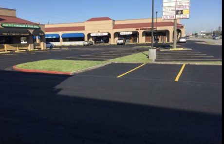 Newly seal-coated blacktop parking lot.