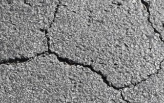A cracked asphalt driveway.